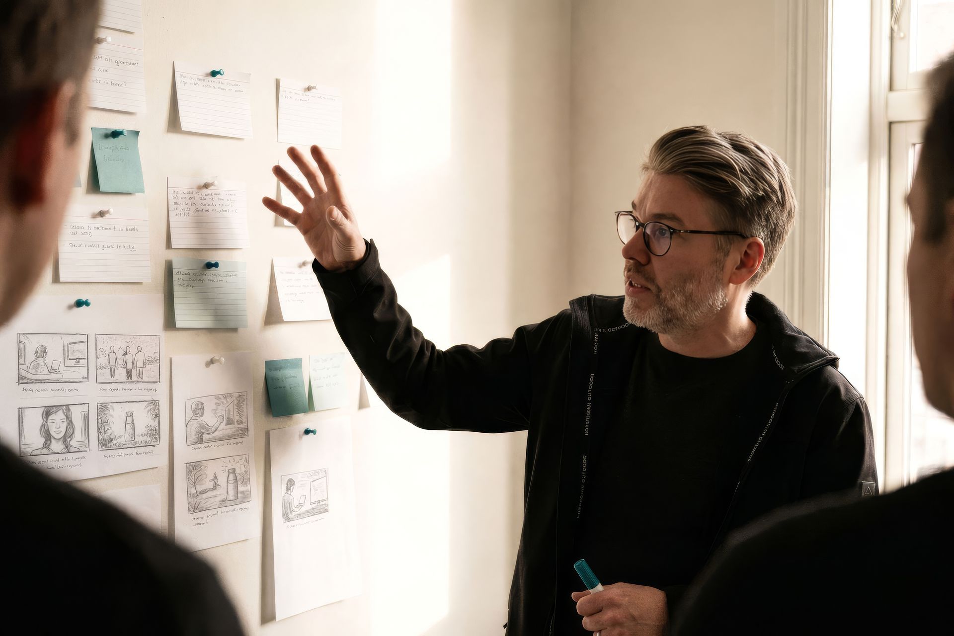 A strategy workshop in progress, a facilitator working through pinned notes on the wall